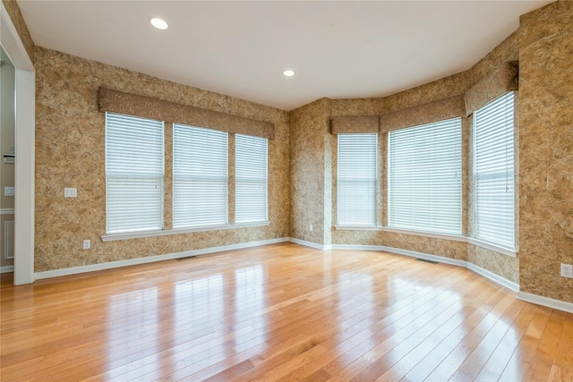 spare room with hardwood / wood-style floors