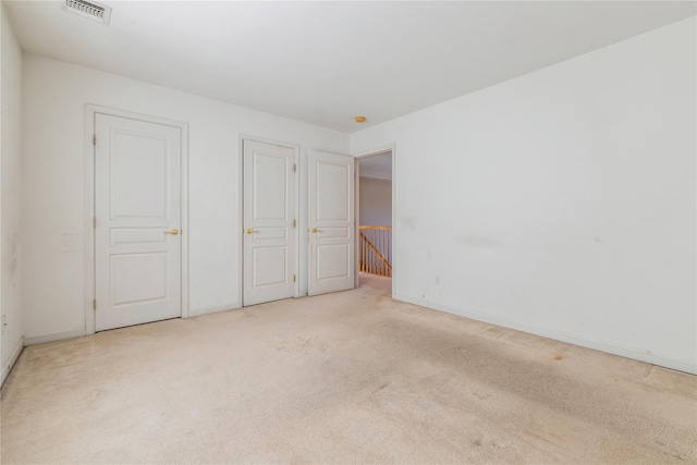 unfurnished bedroom with light colored carpet