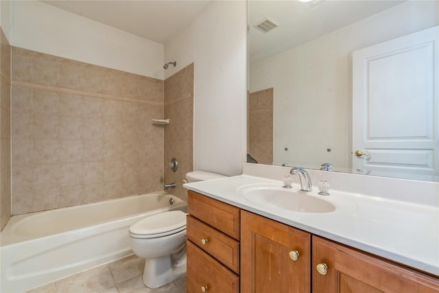 full bathroom with tile patterned floors, vanity, tiled shower / bath combo, and toilet