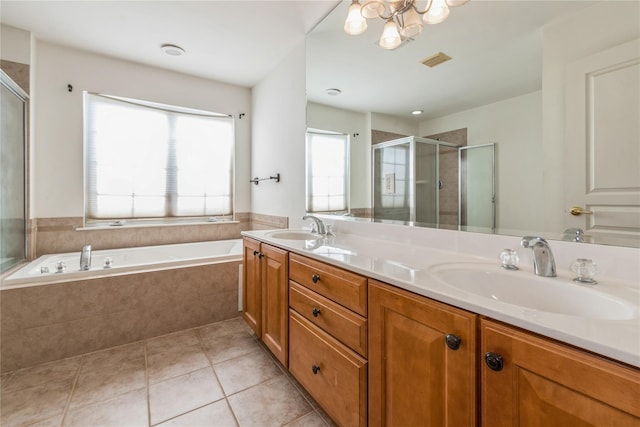 bathroom featuring tile patterned flooring, shower with separate bathtub, vanity, and a notable chandelier