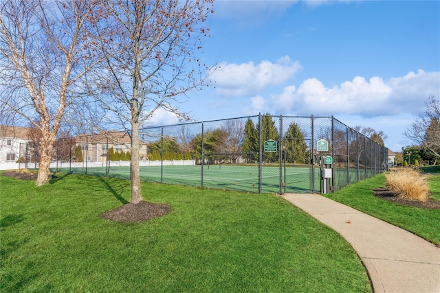 view of tennis court with a lawn