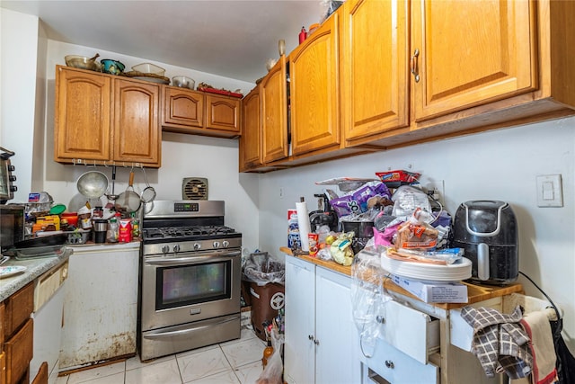 kitchen with gas stove and light tile patterned floors