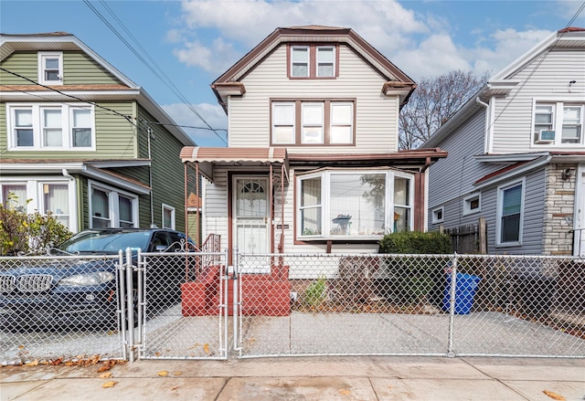 218-25 101st Ave, Queens Village, NY 11429 - view of front facade with a gate and a fenced front yard