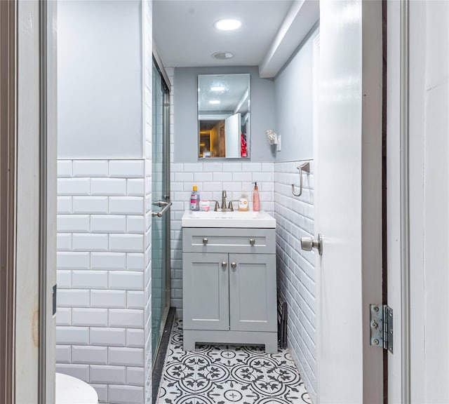 218-25 101st Ave, Queens Village, NY 11429 - bathroom with tile walls, tile patterned flooring, toilet, vanity, and recessed lighting