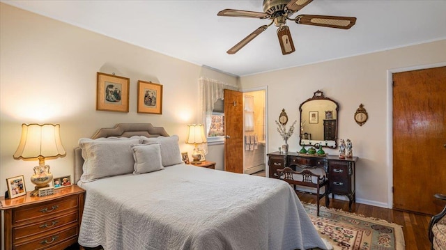 bedroom with dark hardwood / wood-style flooring, baseboard heating, and ceiling fan