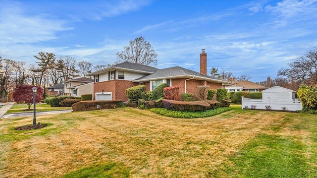 view of side of home featuring a lawn and a garage