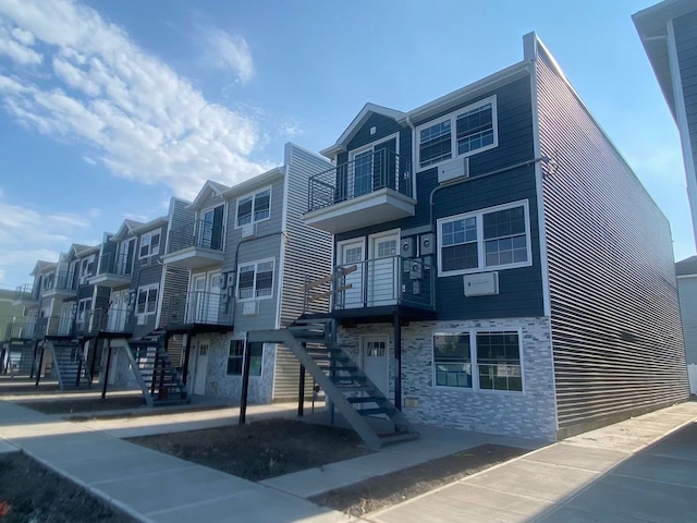 view of building exterior featuring a wall mounted air conditioner