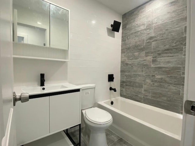 full bathroom with vanity, tiled shower / bath combo, and toilet