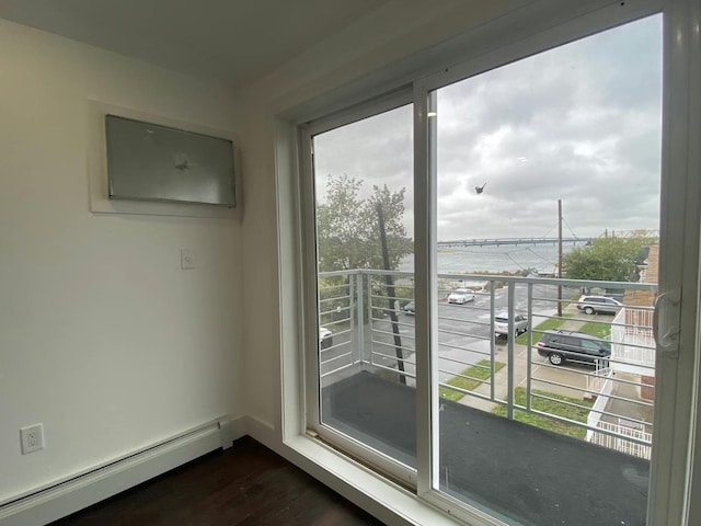 doorway to outside featuring dark hardwood / wood-style flooring and a baseboard heating unit