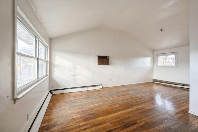 unfurnished living room with an AC wall unit, dark wood-type flooring, vaulted ceiling, and a baseboard heating unit