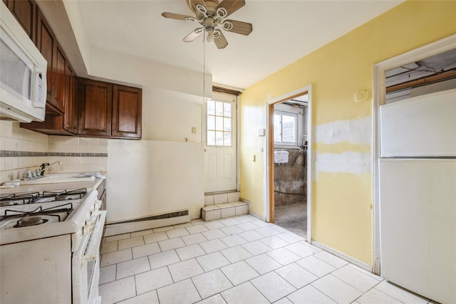 kitchen featuring backsplash, white appliances, ceiling fan, light tile patterned floors, and a baseboard radiator