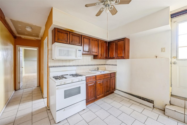 kitchen featuring ceiling fan, sink, tasteful backsplash, white appliances, and light tile patterned floors