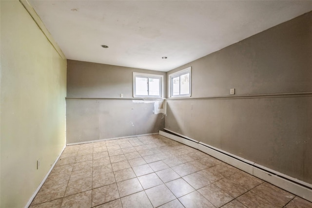 tiled spare room with a baseboard radiator