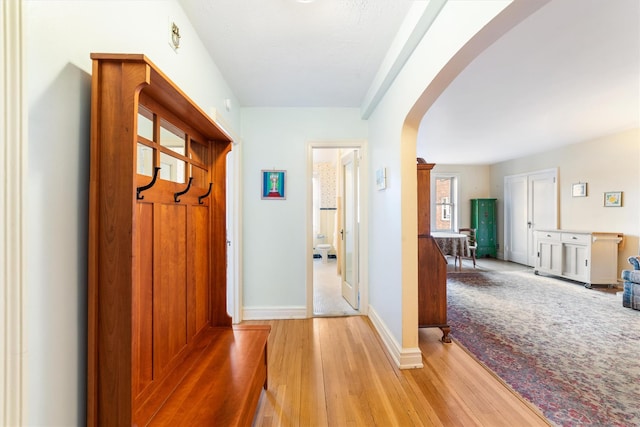 corridor with light hardwood / wood-style flooring