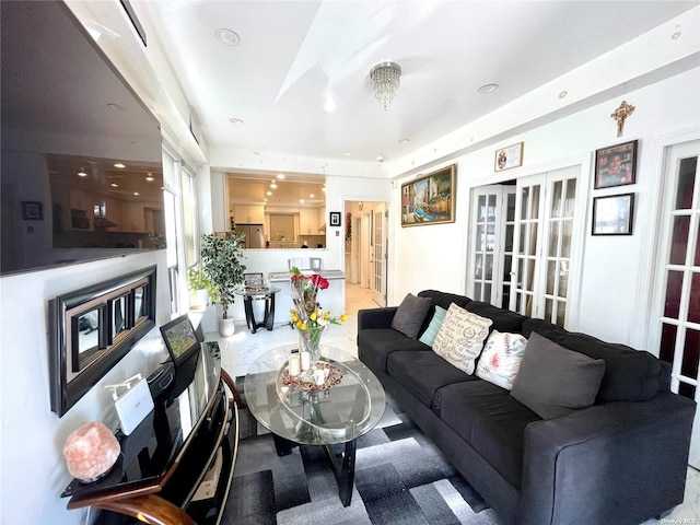 living room featuring french doors and an inviting chandelier