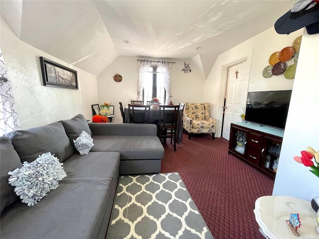 living room featuring dark colored carpet and vaulted ceiling