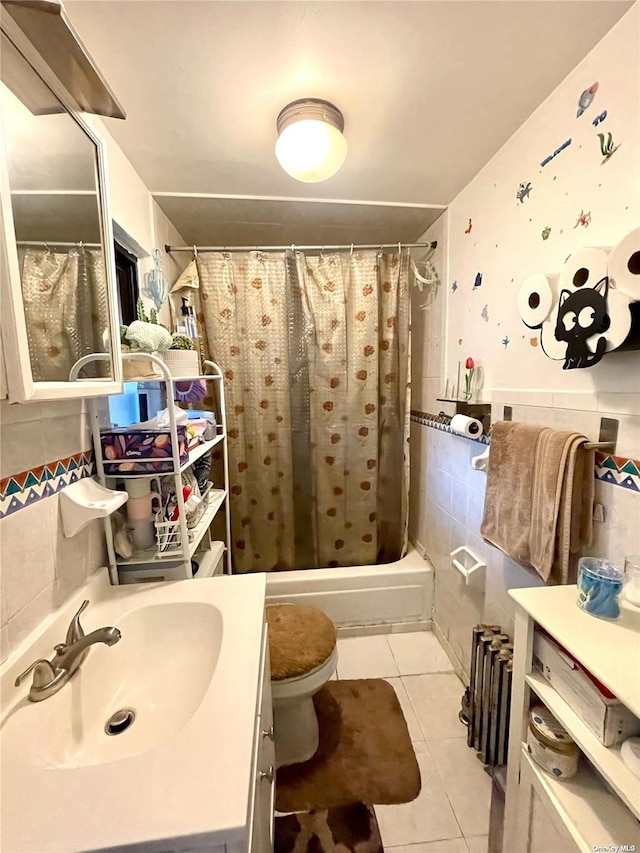 full bathroom featuring vanity, tile patterned flooring, toilet, shower / bath combo with shower curtain, and tile walls