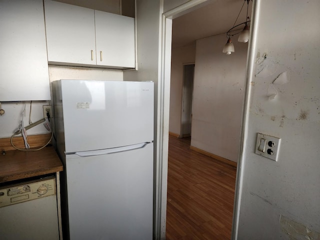 kitchen with white cabinetry, wood-type flooring, and white appliances