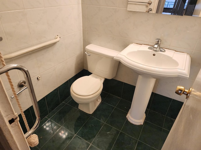 bathroom featuring tile patterned flooring, backsplash, toilet, and tile walls