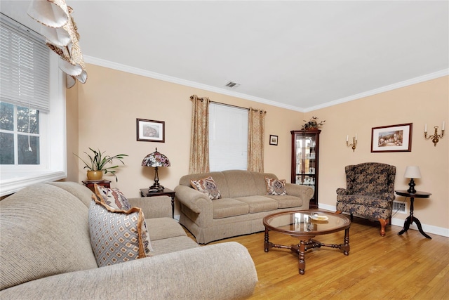 living room featuring light hardwood / wood-style flooring and ornamental molding