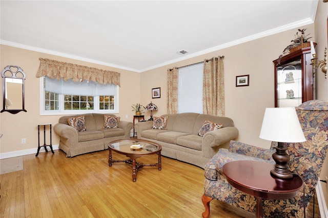 living room with light hardwood / wood-style floors and crown molding