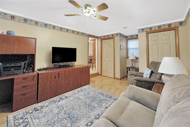 living room with ceiling fan and light wood-type flooring