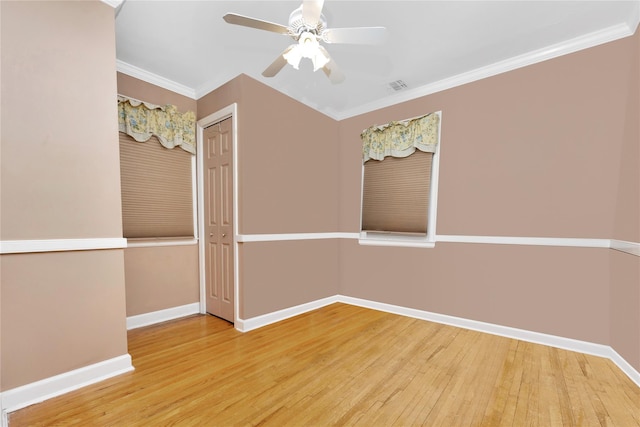 unfurnished room with ceiling fan, ornamental molding, and hardwood / wood-style flooring