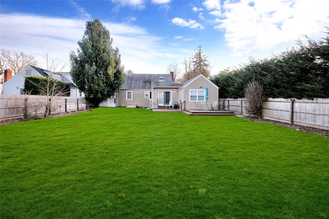 rear view of property featuring a lawn and a deck