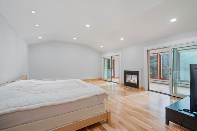 bedroom featuring a multi sided fireplace, access to exterior, vaulted ceiling, and light wood-type flooring