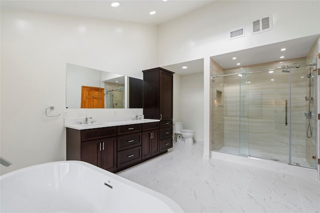 full bathroom with vanity, toilet, shower with separate bathtub, and a high ceiling