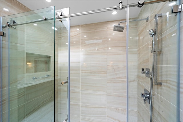 bathroom with a shower with door