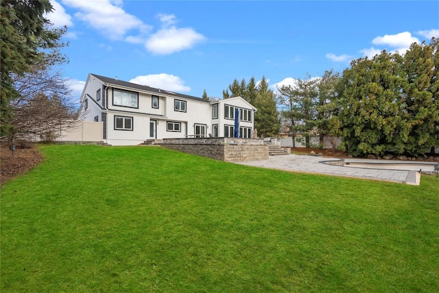 back of house featuring a lawn