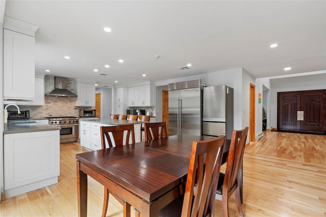 dining area with light hardwood / wood-style flooring and sink