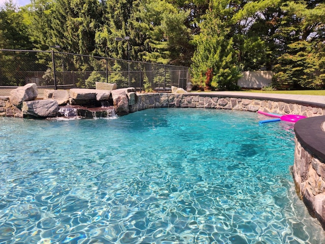 view of swimming pool featuring pool water feature