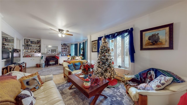 living room featuring built in shelves, ceiling fan, and hardwood / wood-style flooring