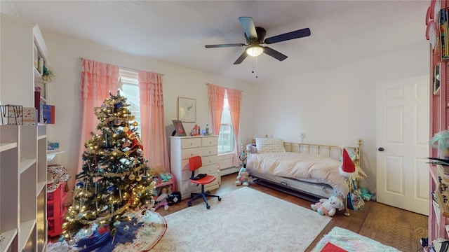 bedroom with ceiling fan and dark hardwood / wood-style floors