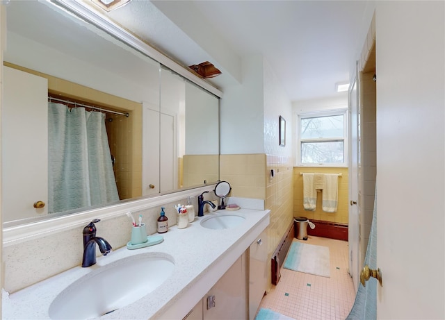 bathroom featuring tile patterned floors, vanity, and tile walls