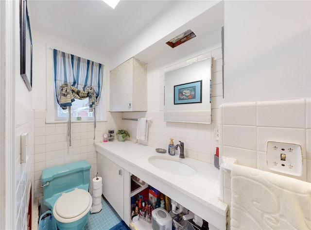 bathroom featuring toilet, sink, and tile walls