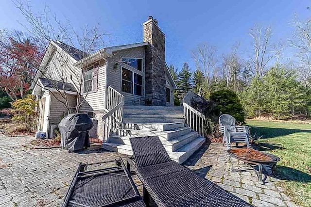 back of property with a patio and a lawn