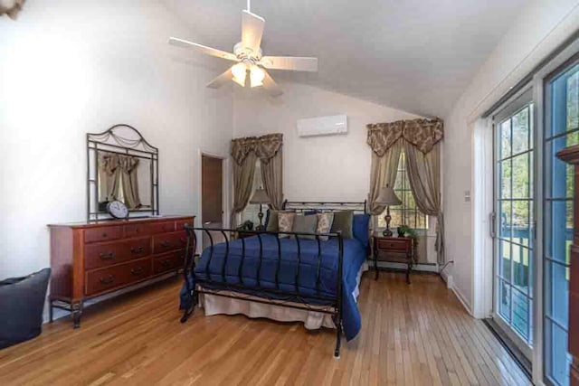 bedroom featuring ceiling fan, wood-type flooring, an AC wall unit, and vaulted ceiling