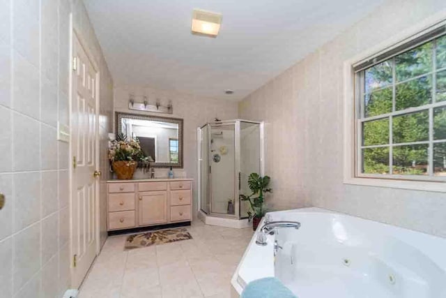 bathroom with tile patterned floors, vanity, and independent shower and bath