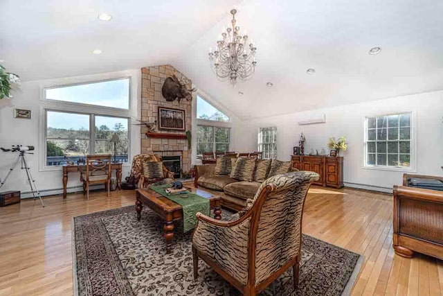 living room with high vaulted ceiling, light wood-type flooring, a fireplace, a baseboard radiator, and a notable chandelier