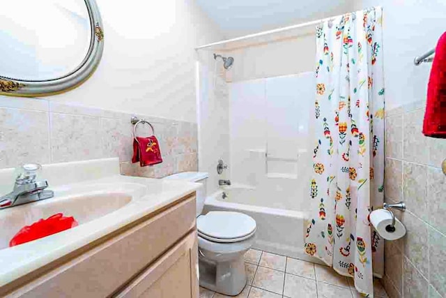 full bathroom with shower / bathtub combination with curtain, tile walls, and toilet