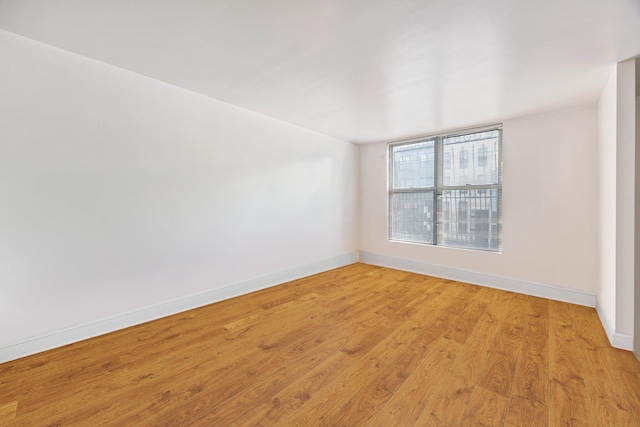 spare room featuring light wood-type flooring