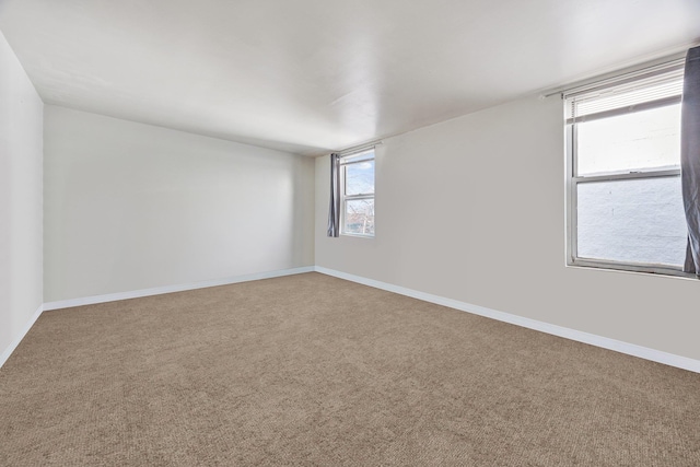 carpeted empty room with plenty of natural light