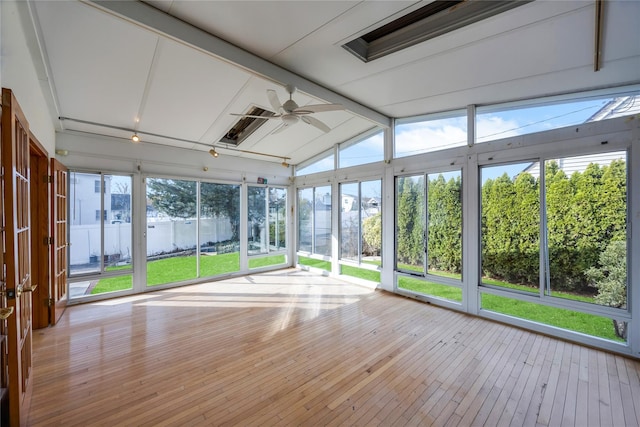 unfurnished sunroom with vaulted ceiling with beams and ceiling fan