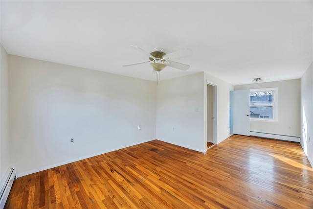 spare room with ceiling fan, a baseboard radiator, and wood-type flooring