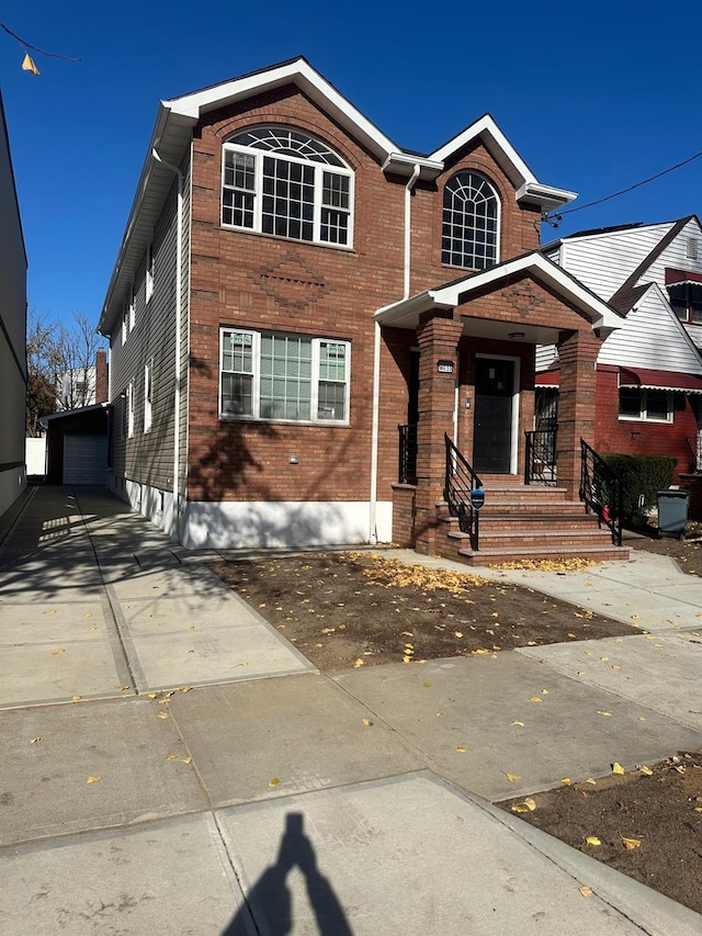 view of front of property featuring a garage and an outdoor structure