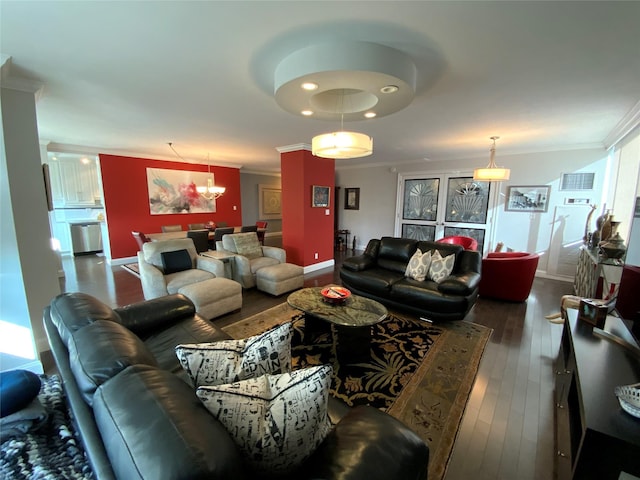 living room featuring a wealth of natural light, ornamental molding, dark hardwood / wood-style floors, and an inviting chandelier