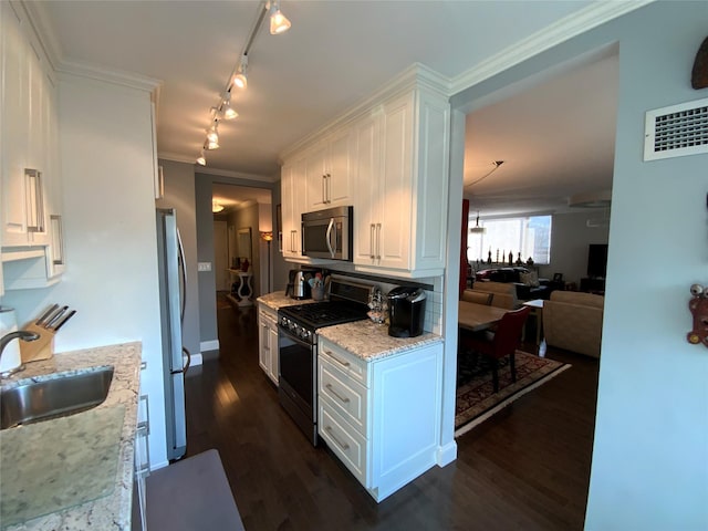 kitchen with light stone countertops, sink, stainless steel appliances, dark hardwood / wood-style floors, and white cabinets